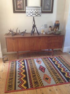 Captain' rug in washed red and wet sand.